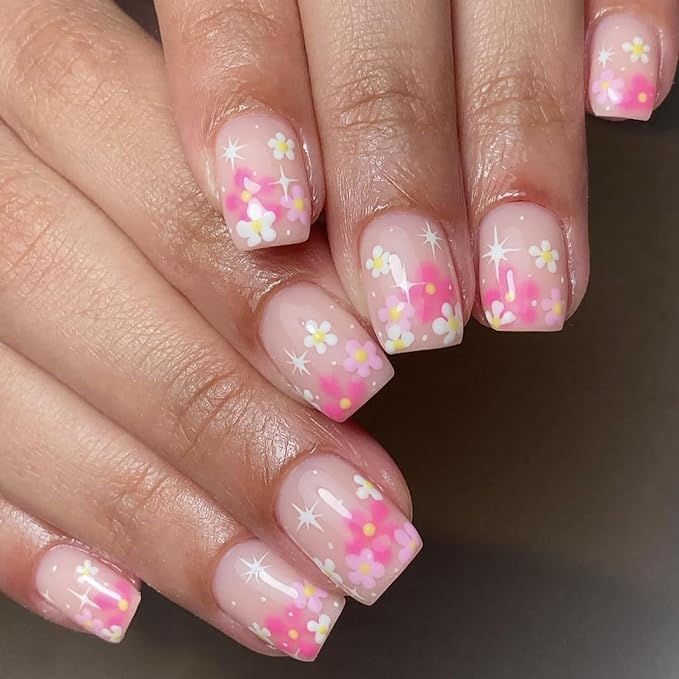 Charming Floral Nail Design with Pink Gradient and Whimsical Accents for a Spring-Inspired Look.