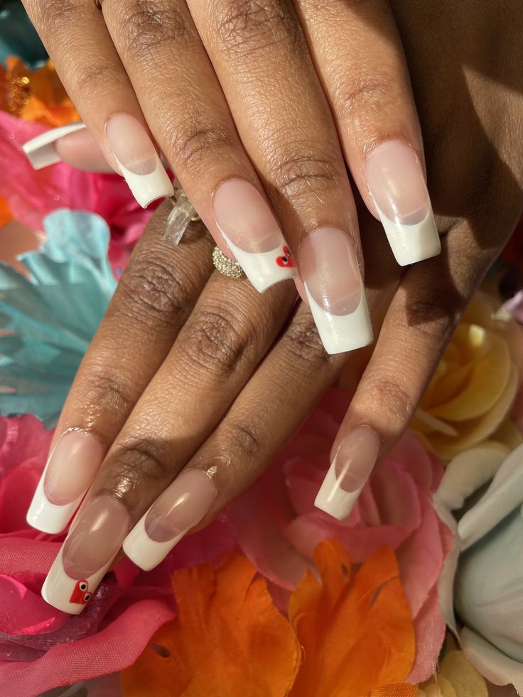 Chic French Tip Nails with Playful Heart Accents for Versatile Elegance