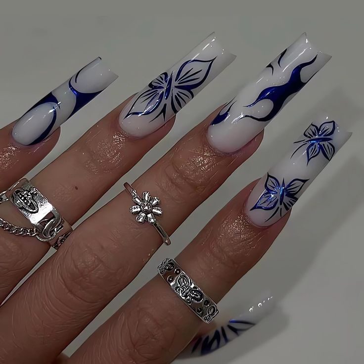 Chic Floral Nail Design with Intricate Blue Patterns on a White Base.