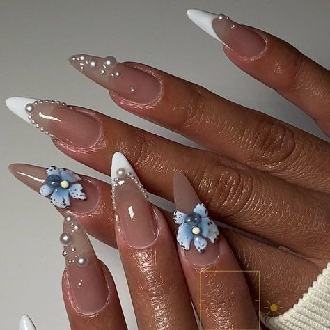 Chic Almond-Shaped Nail Design in Nude and White with Floral and Pearl Accents