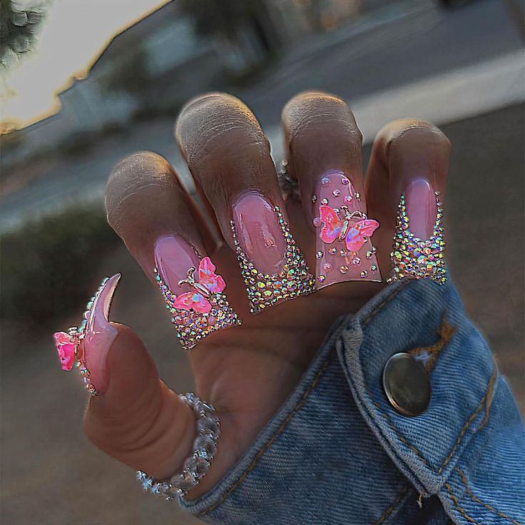 Whimsical Pink Nail Design with Rhinestones and Butterfly Accents