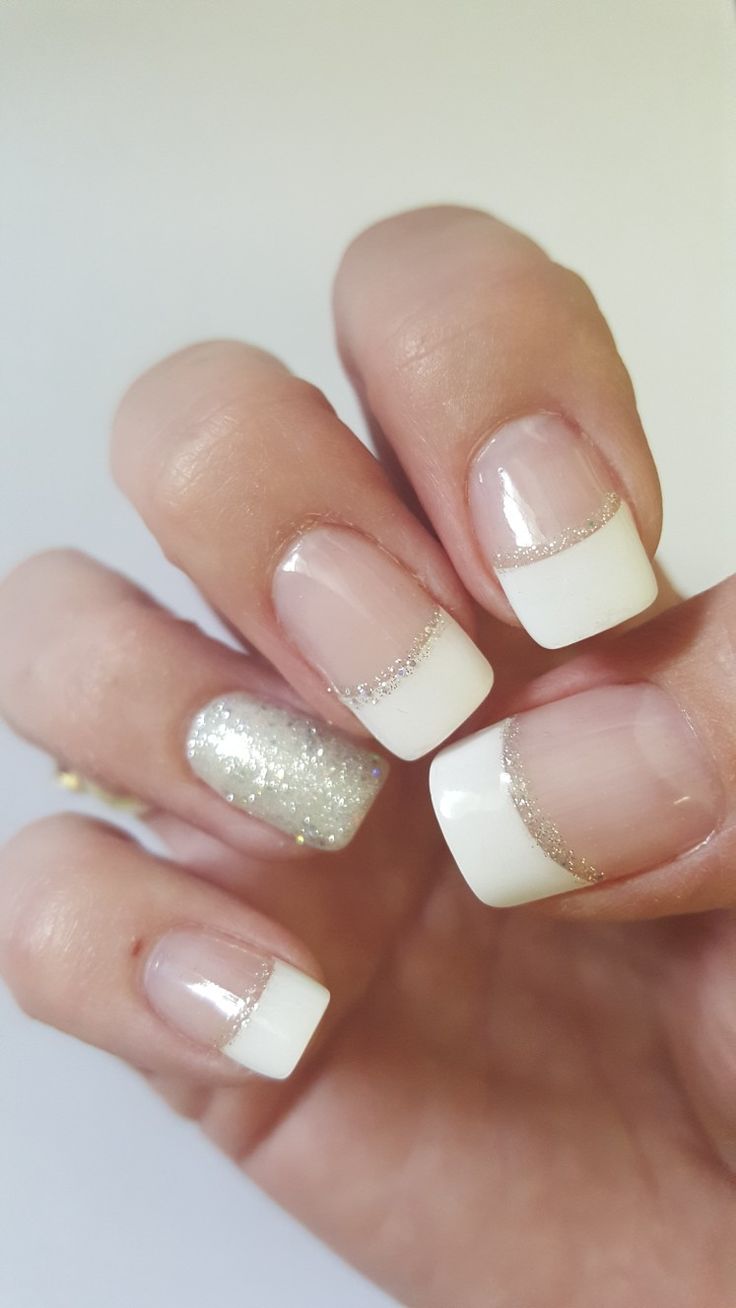 Chic French Manicure with Glitter Accent: A Perfect Blend of Elegance and Glamour.