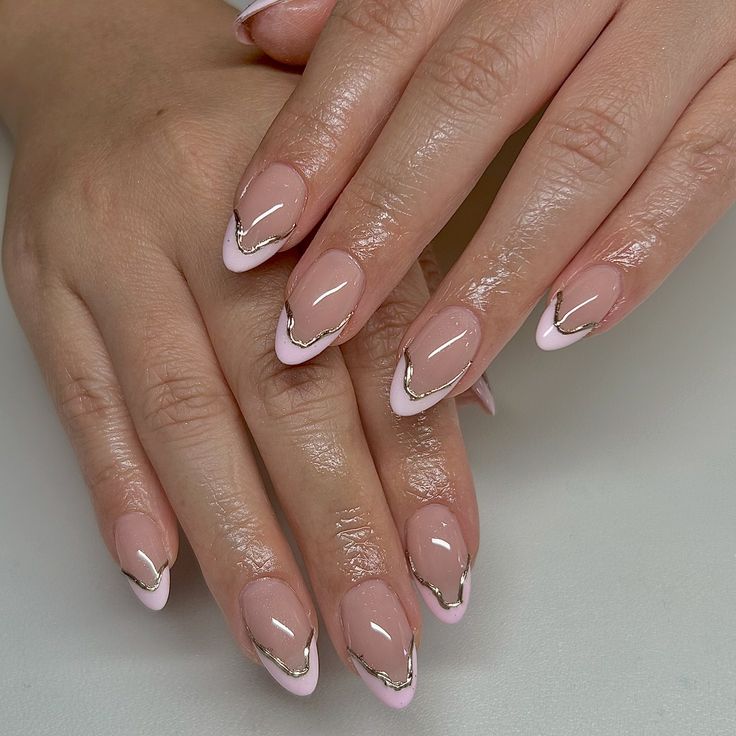 Sleek Nude French Tip Nails with Delicate Pink, White, and Metallic Gold Accents.