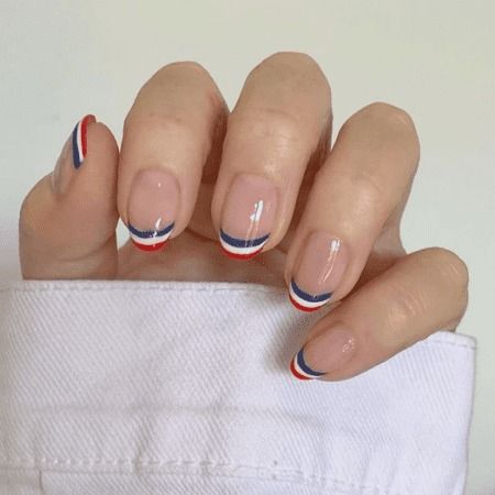 Chic French Tip Nails: Bold Red and Blue Curved Accents for a Modern Twist.