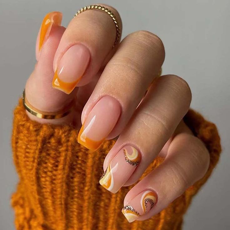 Elegant Autumn-Inspired Nail Design with Nude Base and Vibrant Orange Accents.