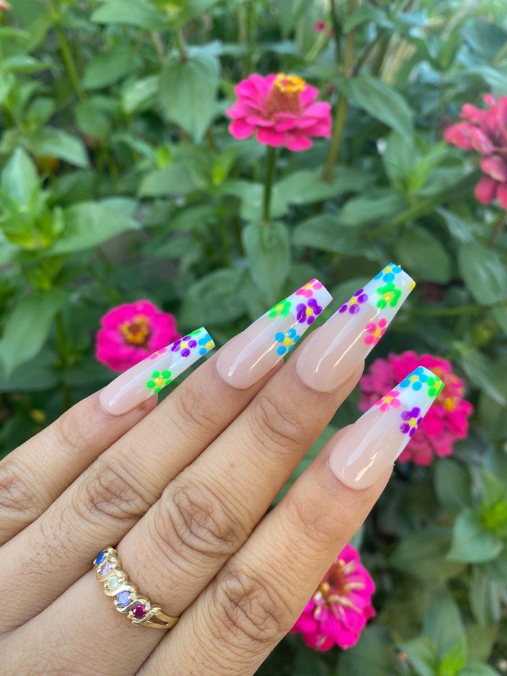 Vibrant Floral Nail Design with Playful Nature Accents.