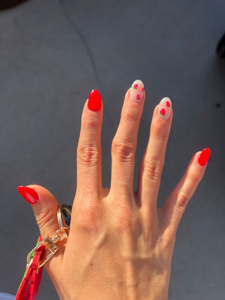 Playful Nail Design: Bold Red and Soft Pink Floral Aesthetics.