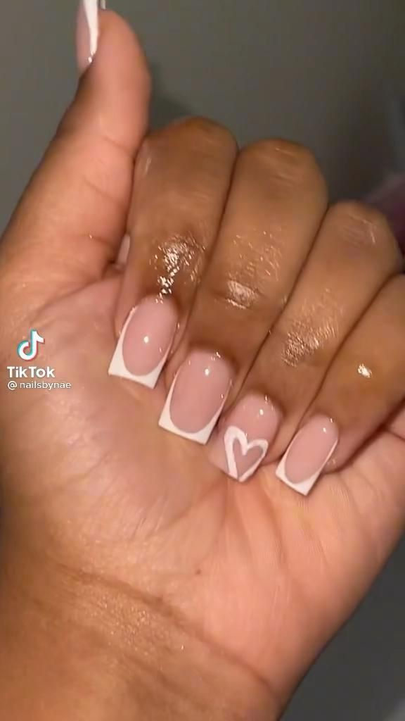 Chic Nude and White Nail Design with Playful Heart Detail