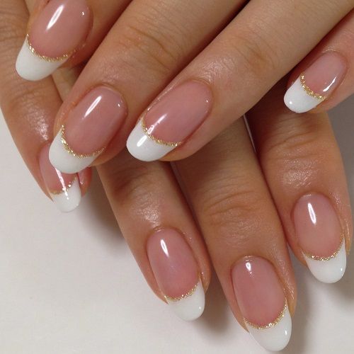 Elegant French Manicure with Glossy Nude Base and Gold Accents.