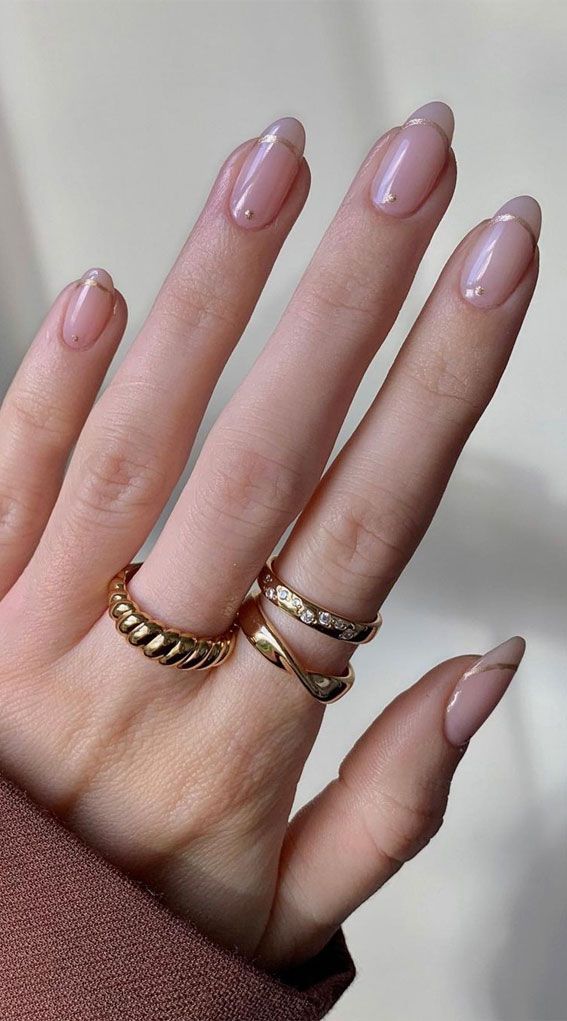 Chic Minimalist Nail Design: Soft Nude Base with Glamorous Gold Tips