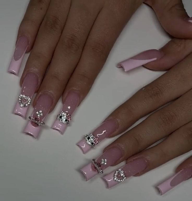 Charming Long Nails with Soft Pink Gloss and Glittering Accents for Special Occasions.