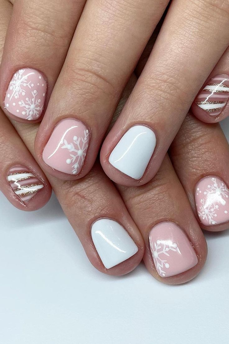 Elegant Winter Nail Design with Soft Pink, White, and Gold Accents