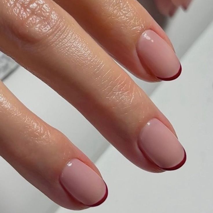 Elegant Nude Nails with Subtle Burgundy French Tips: A Perfect Blend of Minimalism and Boldness