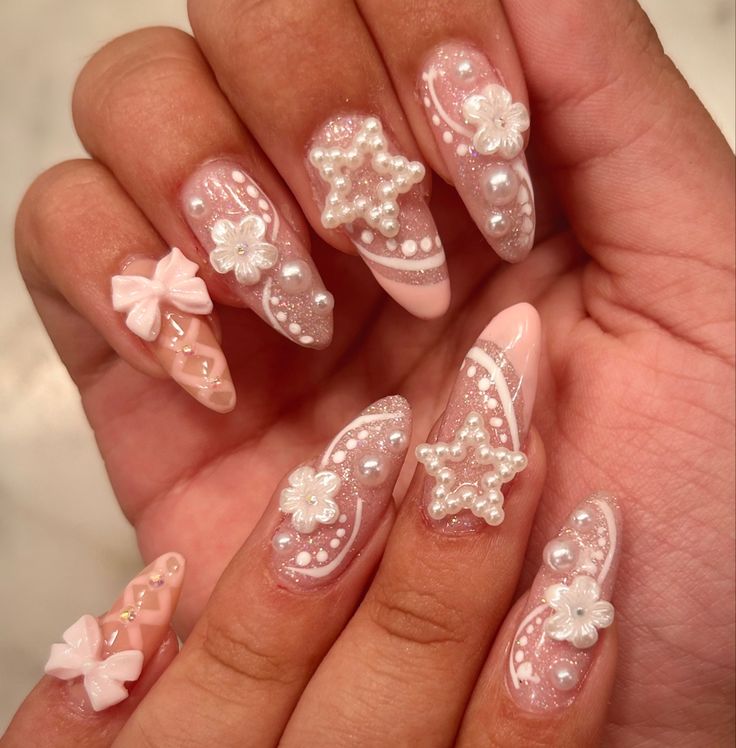 Whimsical Pink Nail Design with Pearls, Floral Accents, and Charming Bows.