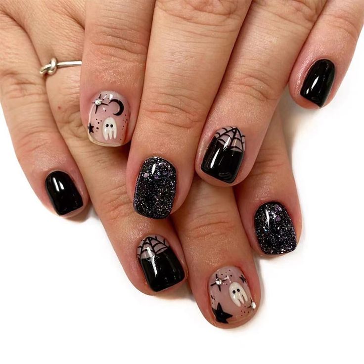 Whimsical Black and Glittery Ghost Nail Design for a Spooky Halloween Aesthetic.