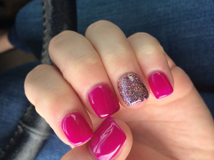 Bold and Chic: Vibrant Pink Nails with Glitter Accent for Every Occasion.