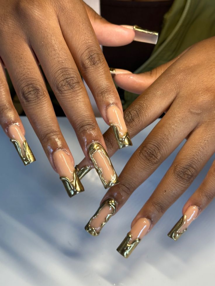 Elegant Nude Beige Nails with Bold Gold Accents for a Striking Statement.