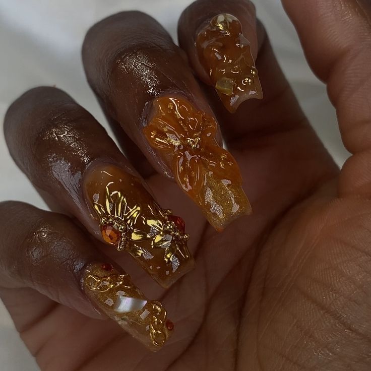 Elegant Floral Nail Design with Rich Brown Base and 3D Embellishments.