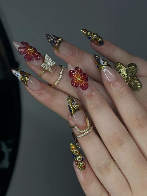 Vibrant Floral Nail Design with 3D Embellishments: A Bold Red and Gold Contrast on a Nude Base.