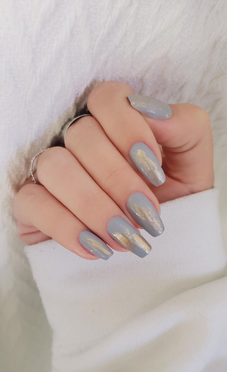 Sophisticated Gray Nail Design with Gold Accents and Elegant Shape.