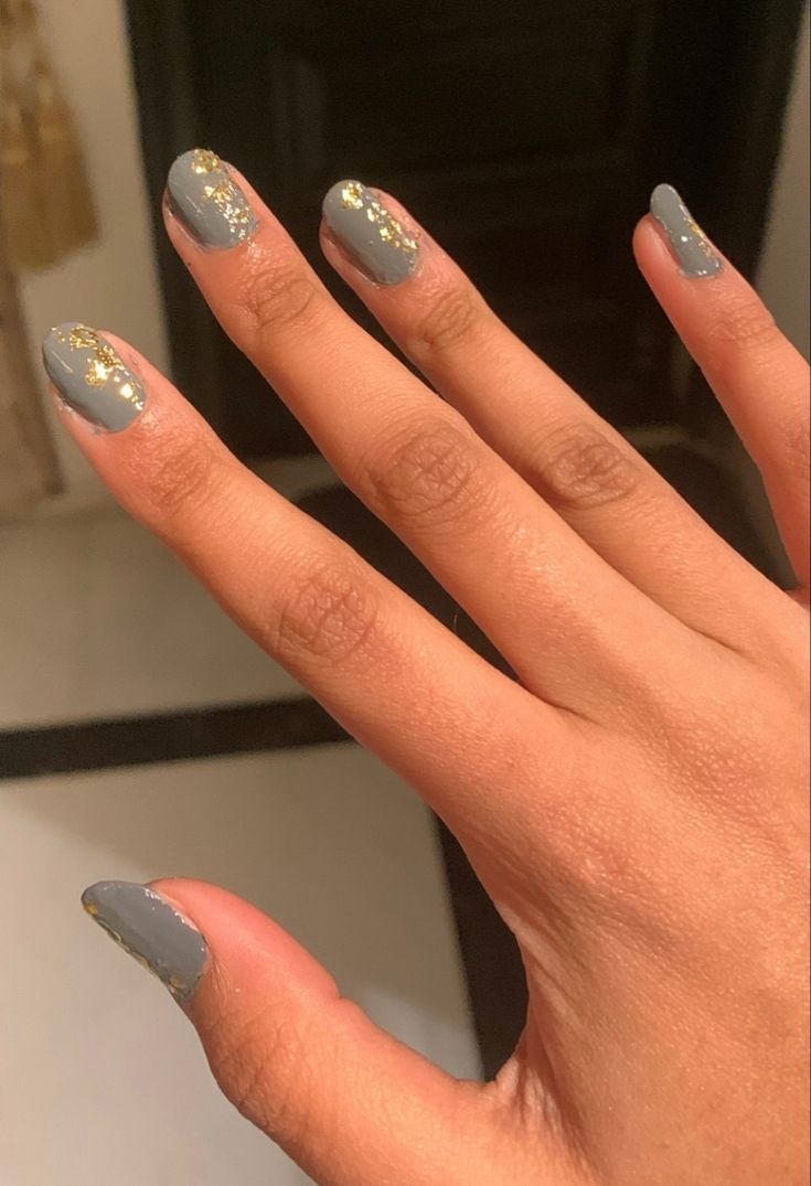 Chic Gray Nail Design with Subtle Gold Glitter Accents for Any Occasion