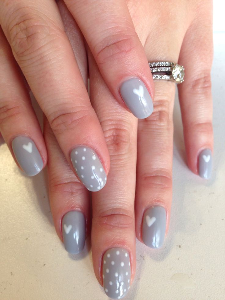 Charming Soft Gray Nail Design with Elegant White Accents and Playful Hearts.