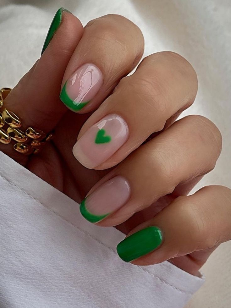 Charming Nail Design: Elegant French Tips with Playful Green Hearts in Pink and Green Palette.