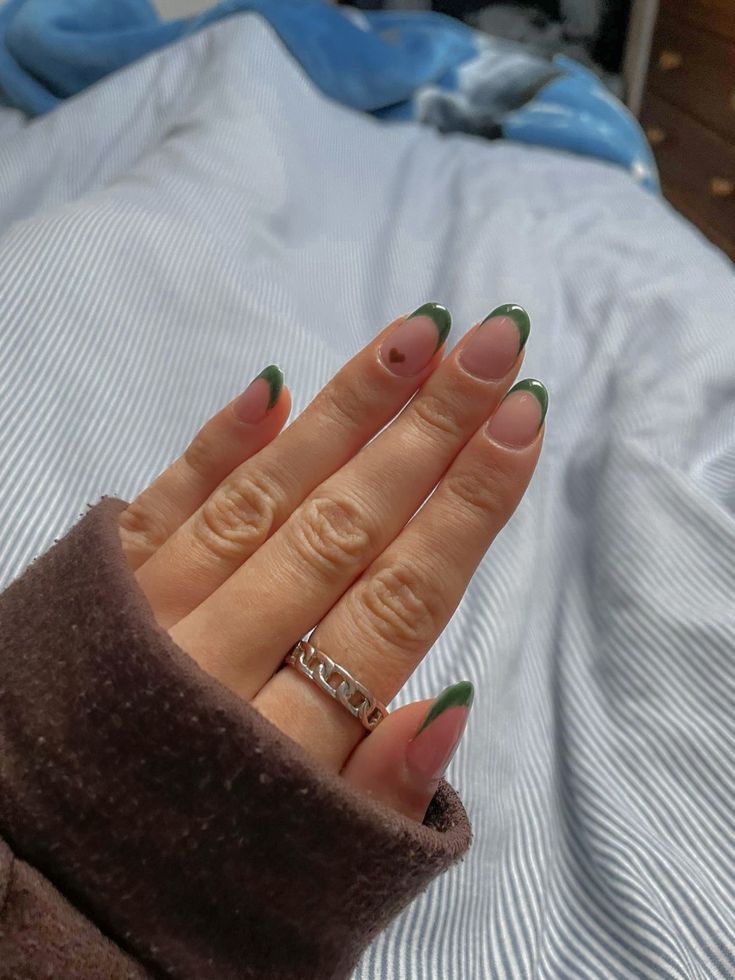 Chic French Tip Nail Design with Rich Green Twist for Elegant Comfort.