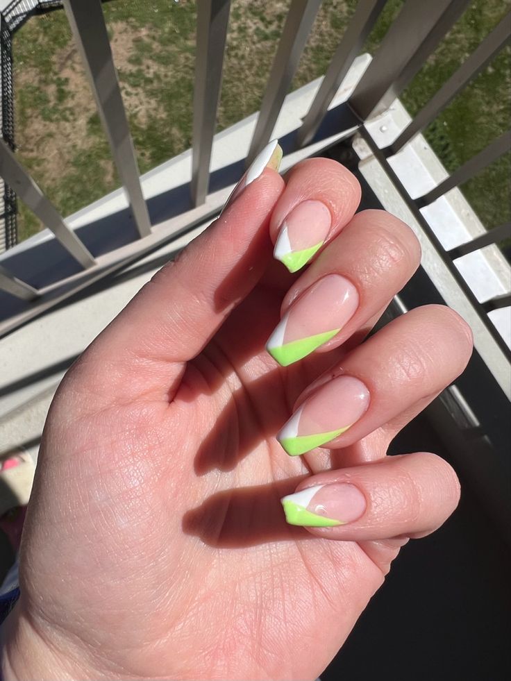 Modern French Tip Nail Design: Bold Green and Classic White on a Clear Base.