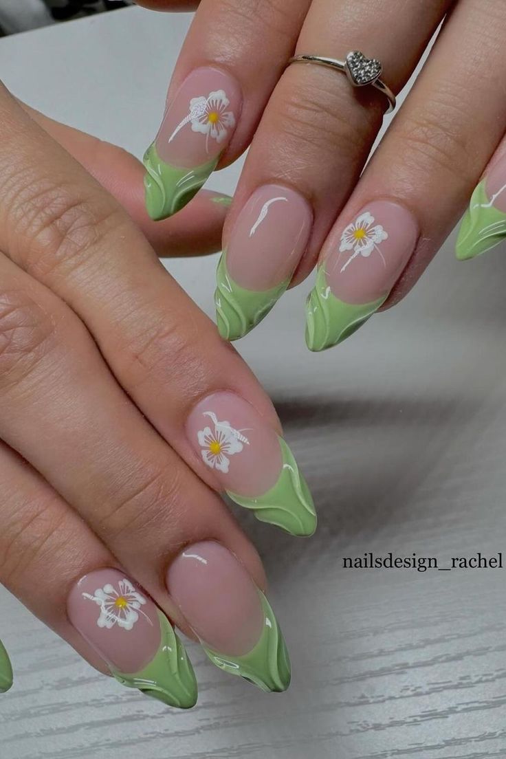 Elegant Floral Nail Design: Soft Pink Base with Vibrant Green Tips and Hand-Painted White Flowers for a Fresh Spring Vibe.