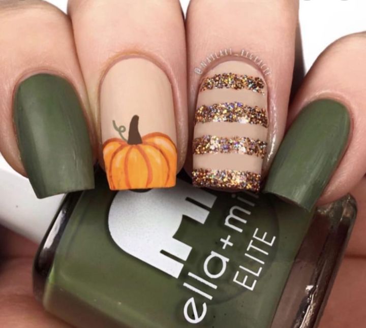 Cozy Autumn Nail Design: Rich Green, Neutral Base, and Pumpkin Accent with Sparkling Glitter Stripes.