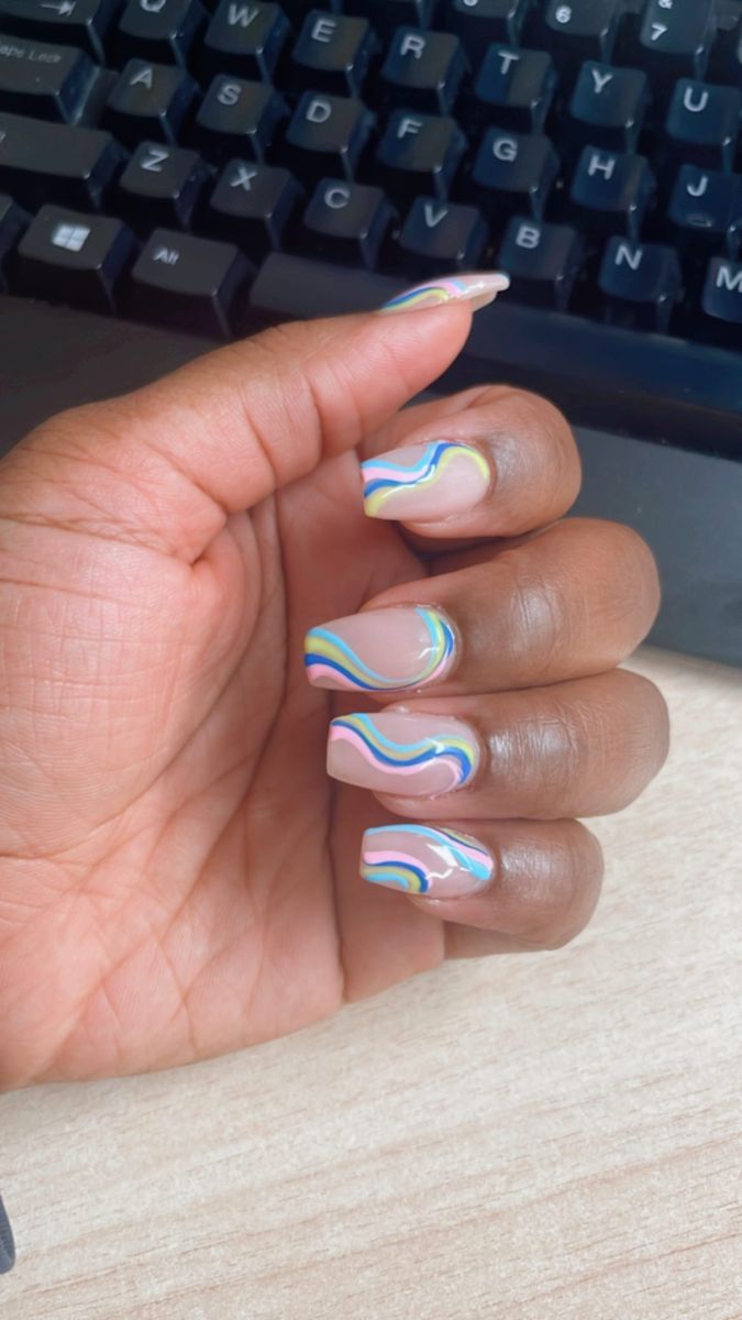 Whimsical Colorful Wave Nail Design with Soft Pink Base and Pastel Swirls