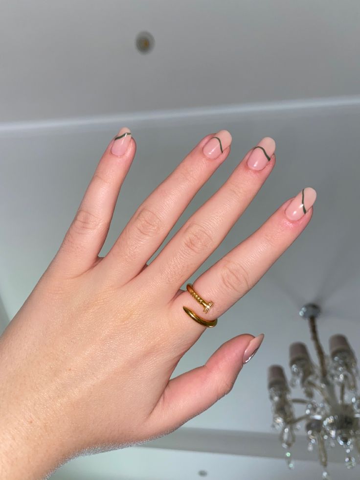 Chic Minimalist Nude Nails with Black Accents and Gold Accessories