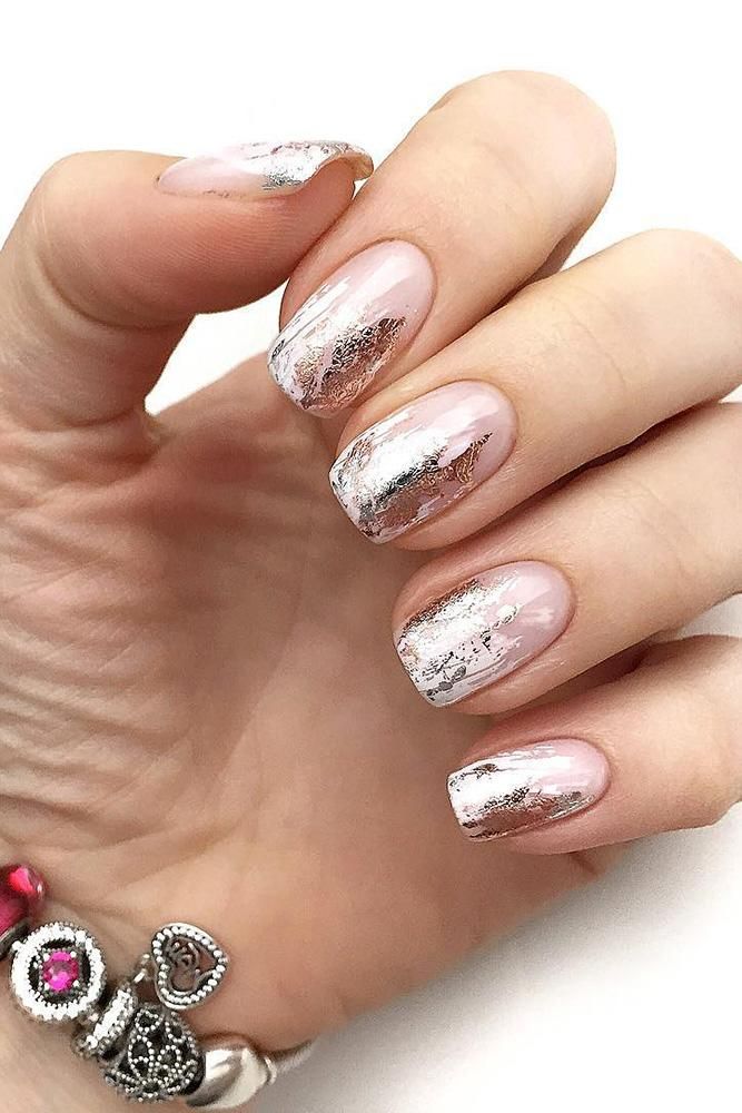 Sophisticated Nail Design: Soft Pink Base with Shimmering Metallic Accents.