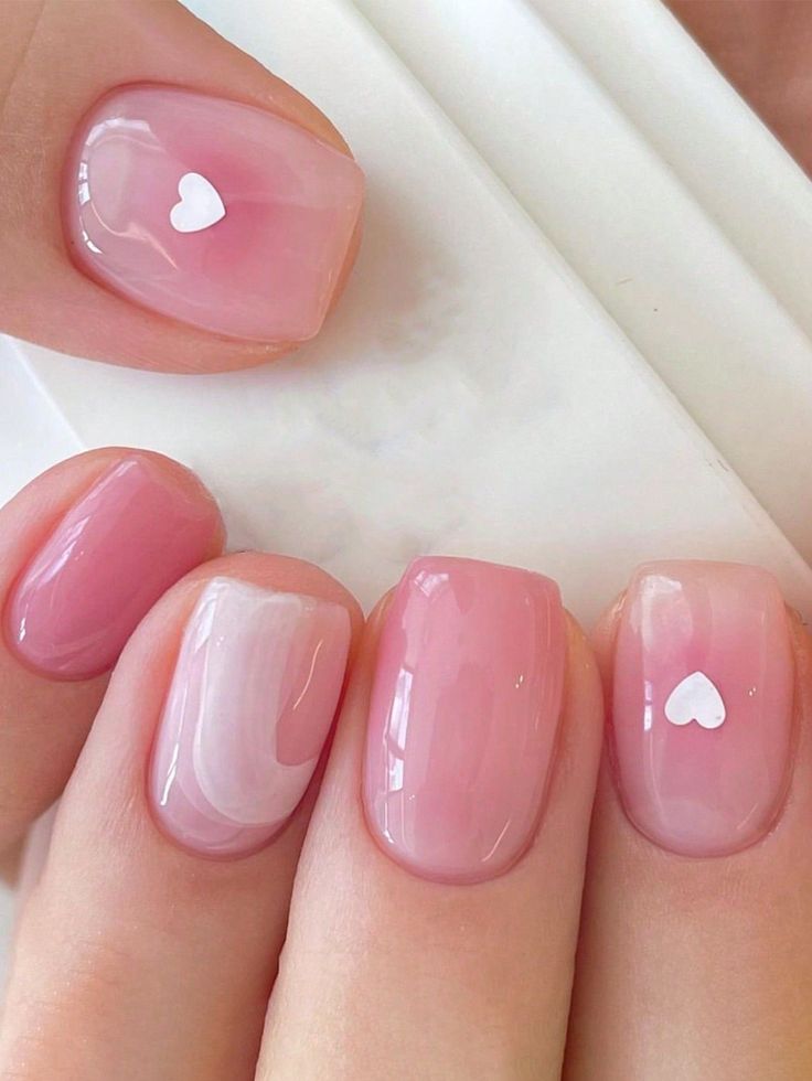 Romantic Pink Nail Design with Glossy Finishes and Playful Heart Accents