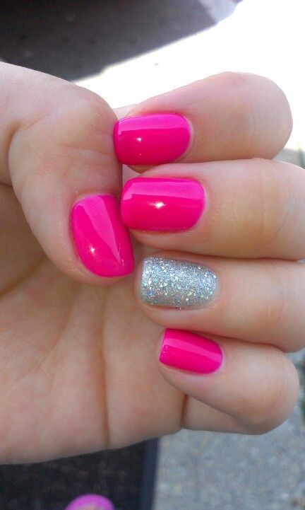 Bold Pink Manicure with Glittery Accent Nail for a Fun and Elegant Look.