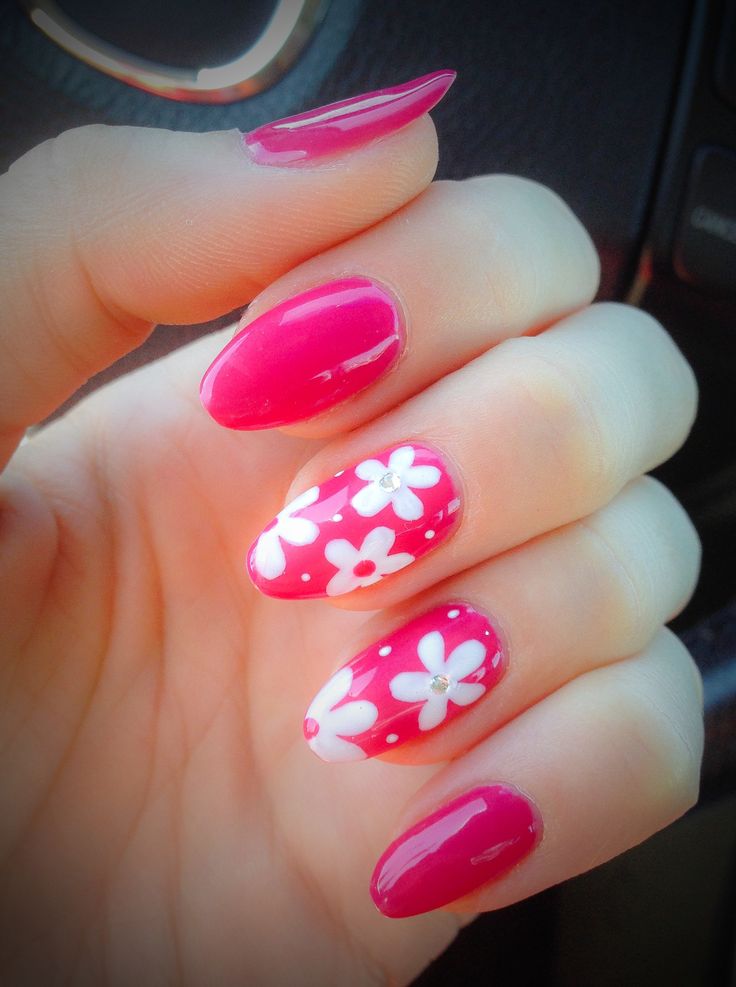 Vibrant Floral Nail Design: Elegant Deep Pink with Intricate White Patterns