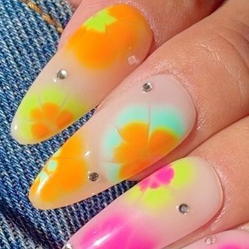 Cheerful Vibrant Floral Nail Design with Bright Colors and Glamorous Rhinestones