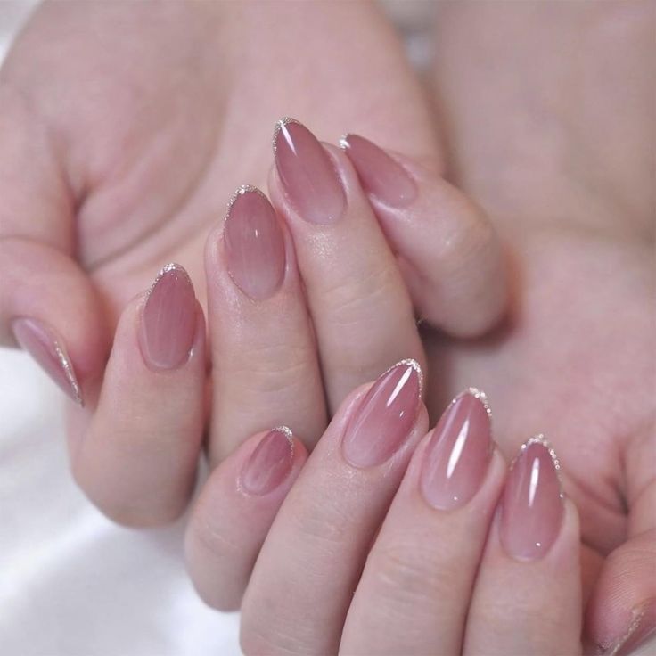 Refined Elegant Nail Design: Soft Pink with Glossy Finish and Silver Accents.