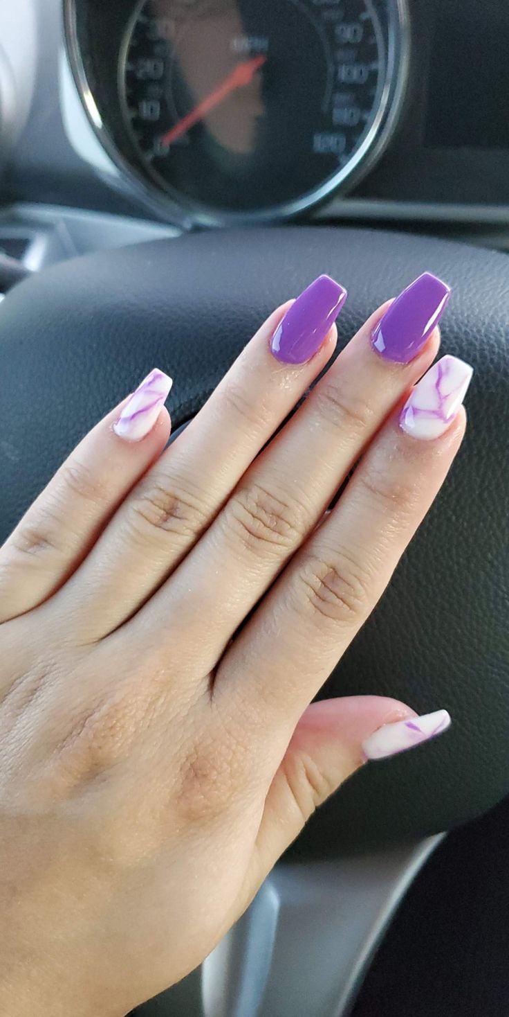 Bold and Chic: Vibrant Purple Nails with Elegant Marble Designs