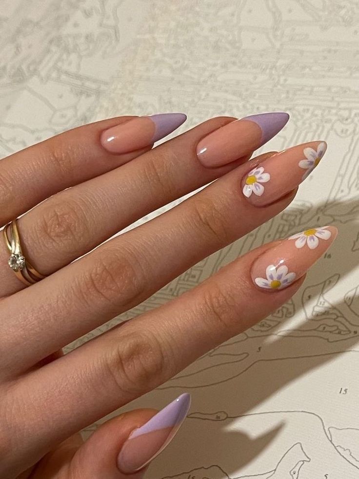 Charming Almond-Shaped Nails in Pastel Peach and Lavender with Delicate Floral Designs.