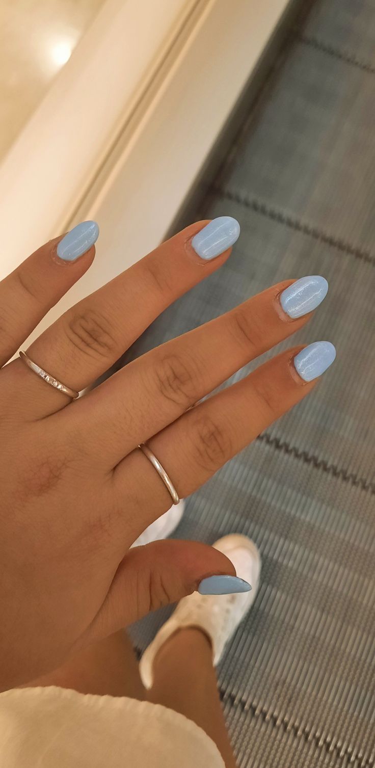 Playful Pastel Blue Nail Design with Glossy Finish and Elegant Silver Accents.