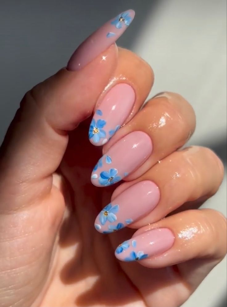 Elegant Spring-Inspired Floral Nail Design with Soft Pink and Intricate Blue Accents.