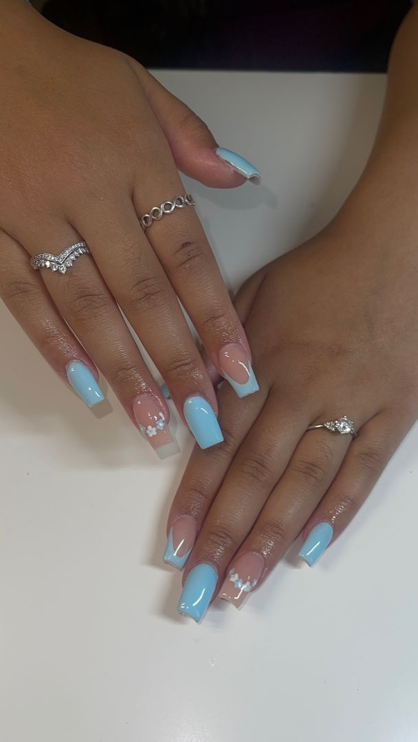 Refreshing Soft Blue Nails with Glossy Finish and Floral Accents.