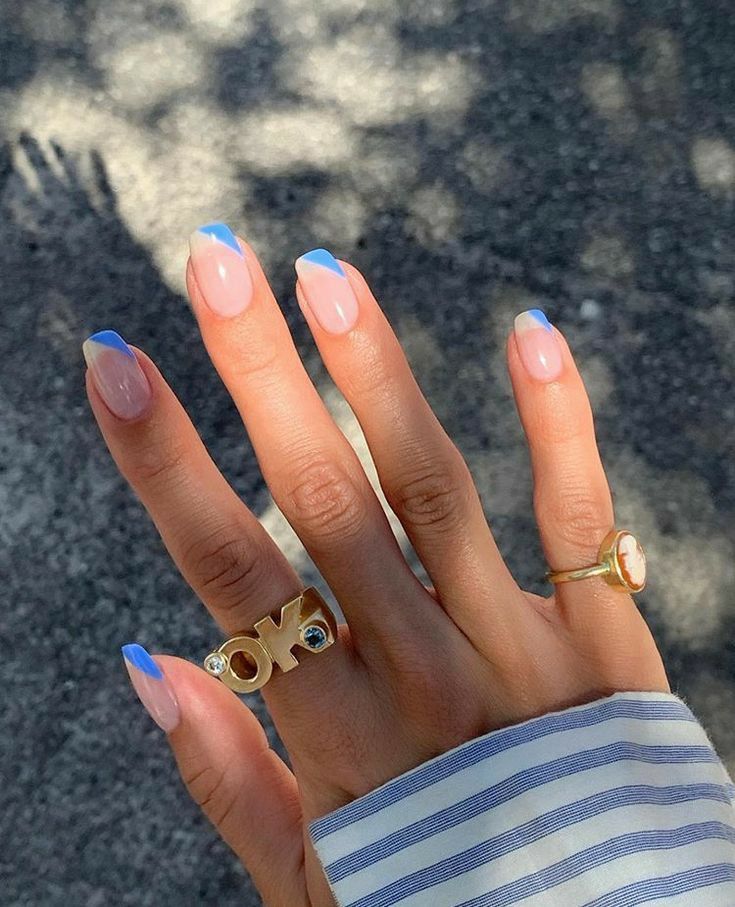 Chic Subtle Pink and Blue French Tip Nail Design with Stylish Ring Accents.