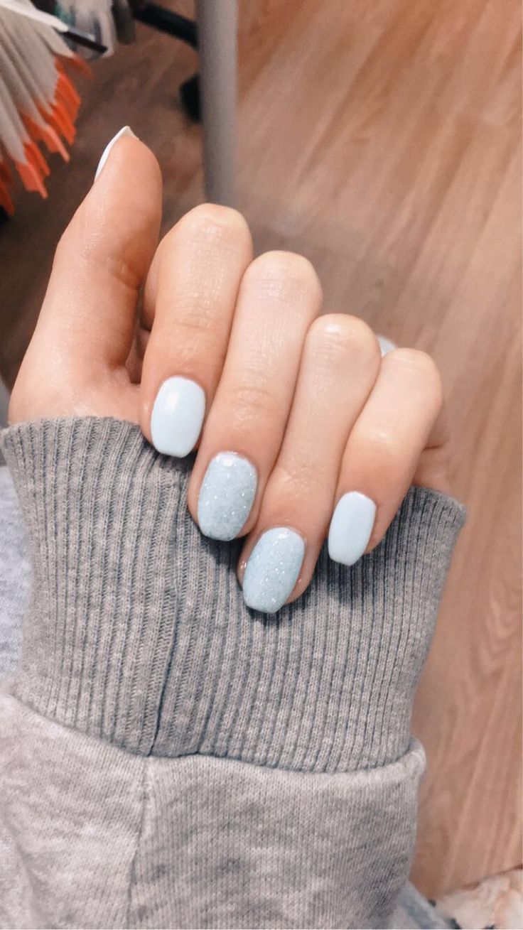 Elegant Pastel Blue Nail Design with Shimmering Silver Accents: A Versatile Trendy Look.