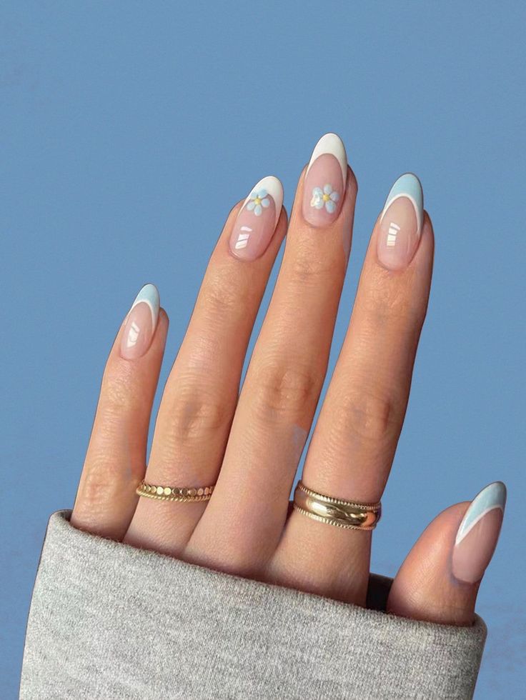 Chic French Tip Nail Design with Soft Blue and Floral Accents.