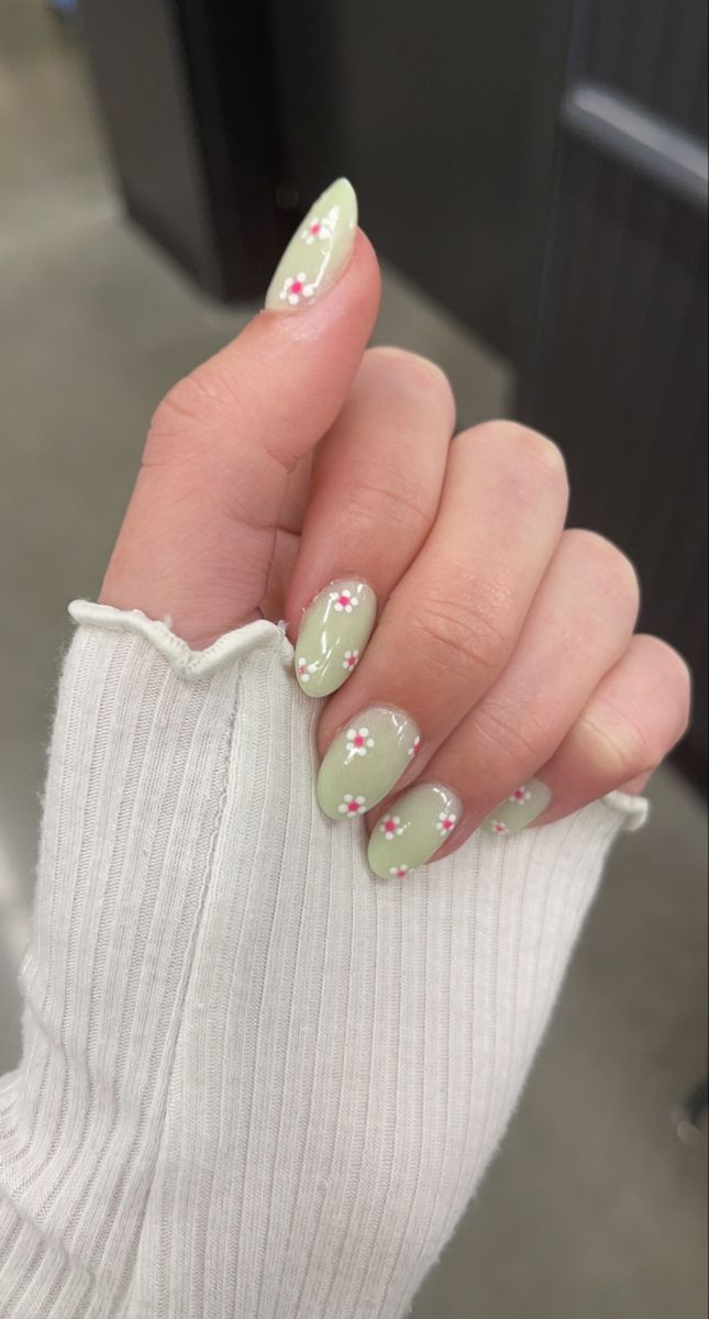 Charming Delicate Floral Nail Design in Soft Green with White and Pink Accents.