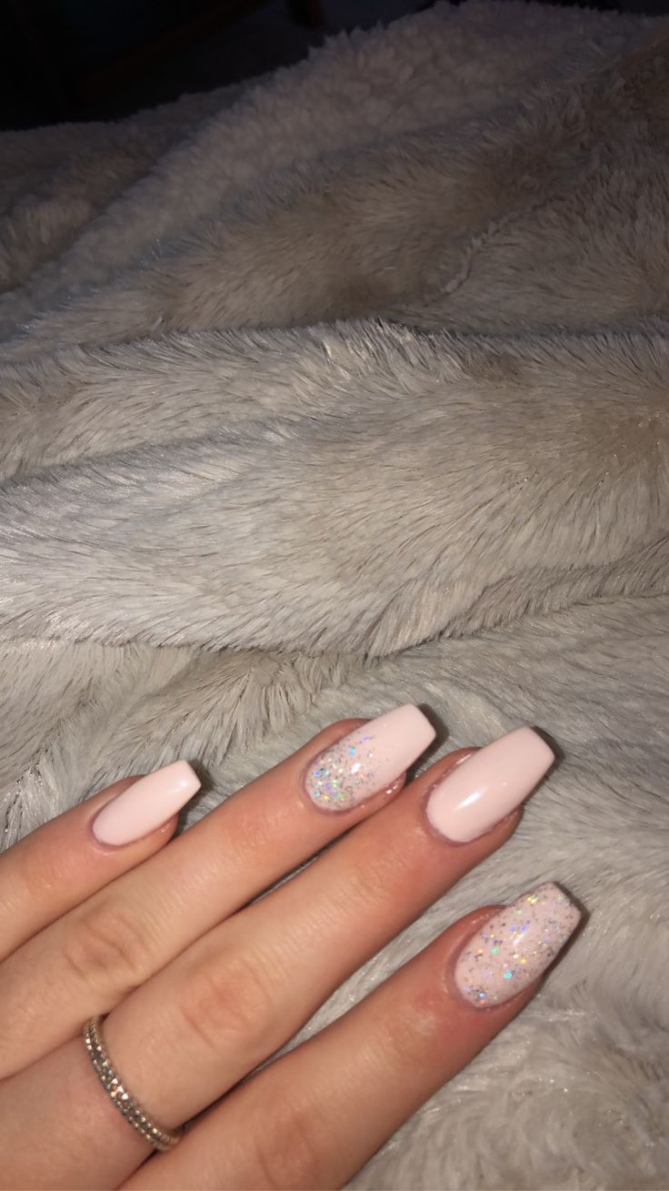 Chic Soft Pink Nail Design Enhanced with Sparkling Iridescent Glitter Accents.