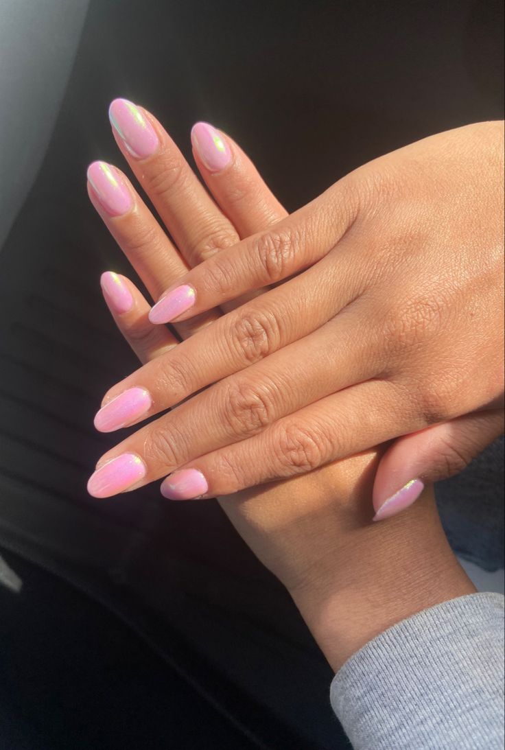 Sophisticated Glossy Pink Almond Nails with Shimmering Accents for Effortless Glamour.